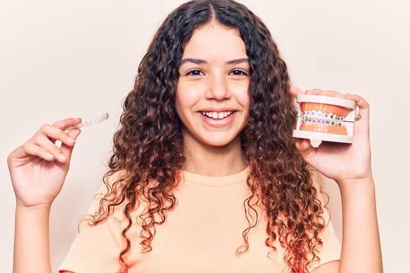 Girl is Hanging a Clear Aligner and Dummy Crown