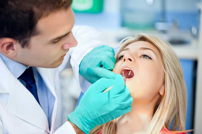 Doctor with Lady Patient In Dental Room