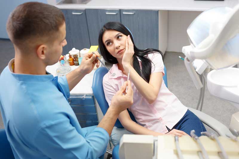 Doctor with Lady Patient In Dental Room