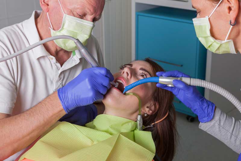 Two Doctors with Patient in Clinic