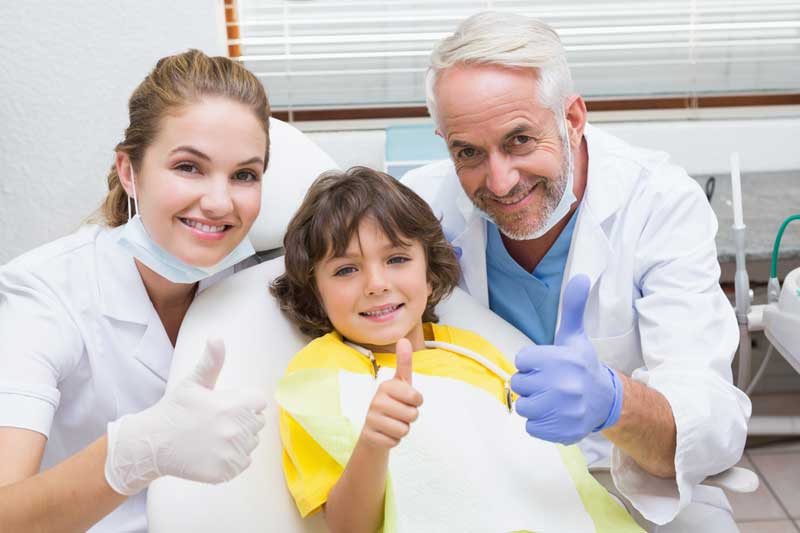 Child Patient with Two Doctors in Clinic